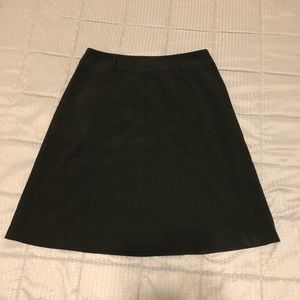 Black A-line knee-length skirt.